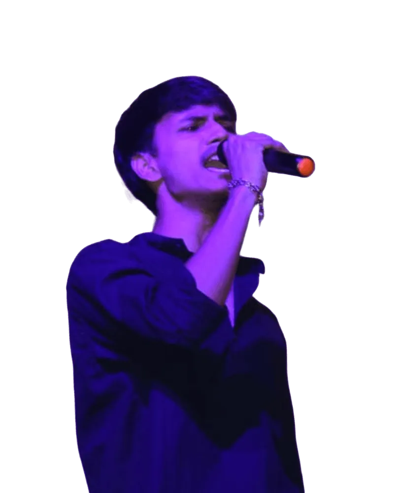 Yogesh singing on stage, mic in hand